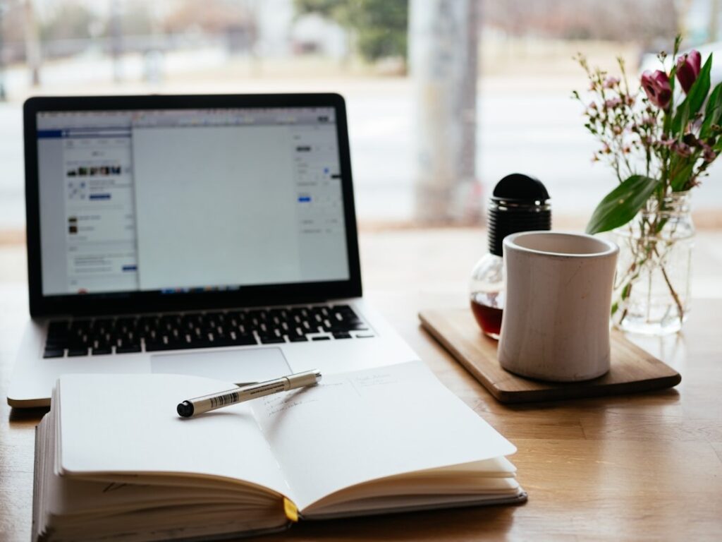 a diary with a pen on it, placed infront of the table